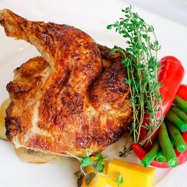 Crispy roasted chicken with fresh thyme, red bell pepper, green beans, and yellow squash.